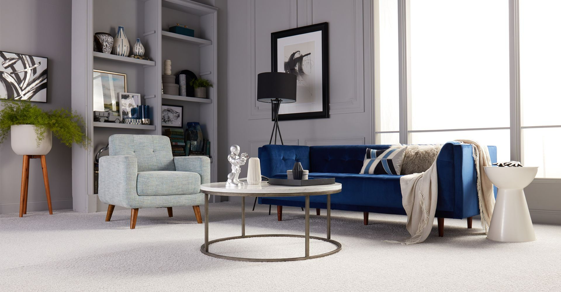 Dad pushing Daughter in Cardboard box on Hardwood Floors in Home.